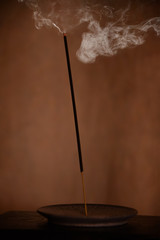 Burning Incense Stick with Billowing Smoke