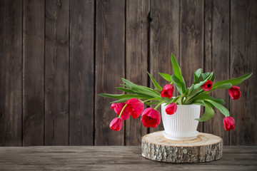 bouquet of red tulips on wooden background