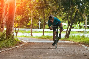 Man cycling road bike in morning