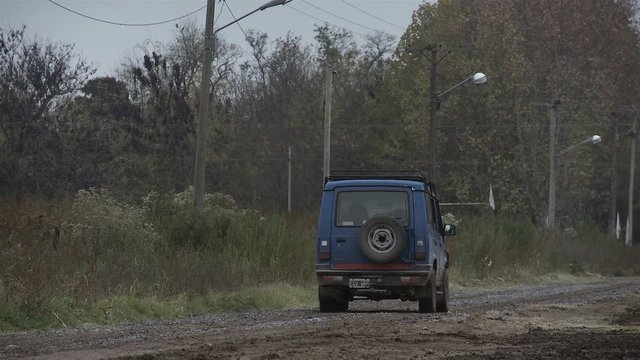 An Old and Blue 4x4 Car on Dirt Road in Gouin, Carmen de Areco, Buenos Aires province, Argentina. 