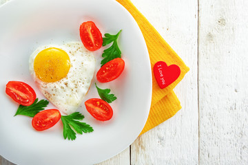 Healthy Breakfast on Valentine's day fried eggs and fresh tomatoes. Dietary food. The view from the top.