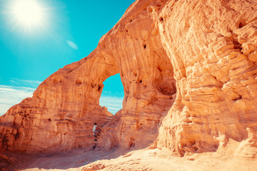 Arch in the rock. A man climbs on a rock. Desert natural landscape. Timna Park. Israel