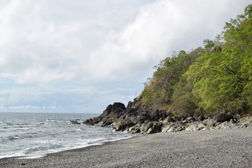 Fototapeta premium seawaves pounding tropical island rocks in outlying shores of Hugom, San Juan, Batangas, Philippines