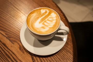 Cup of coffee on blue table.