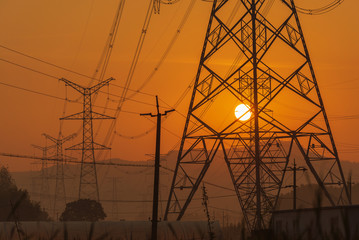 Electricity power pylons during sunset
