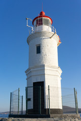 Fototapeta na wymiar Tokarevsky lighthouse against the blue sky.