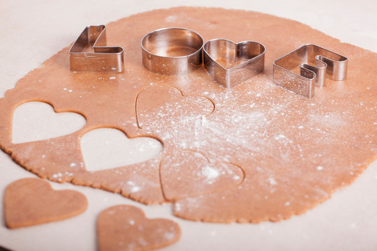 dough and heart-shaped cookies as a symbol of Valentine's Day - Powered by Adobe