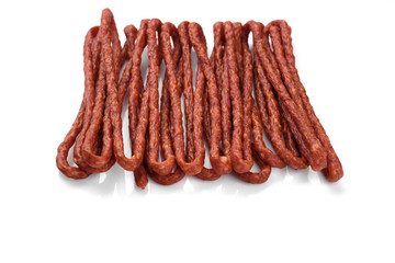 long and thin sausages kabanos on white background, isolated