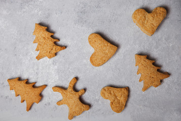 A scattering of Christmas cookies on a gray background. Flat layout. Top view. Christmas and new year concept. Cooking
