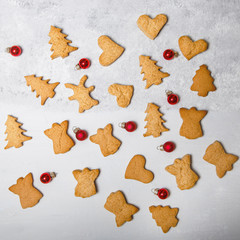 A scattering of Christmas cookies on a gray background. Flat layout. Top view. Christmas and new year concept. Cooking