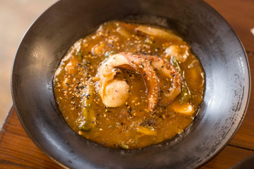 Seafood Risotto served on a black Plate. Octopus Risotto