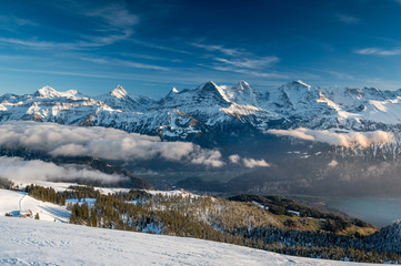 Fototapeta na wymiar Bernese Alps with Eiger, Mönch and Jungfrau with Lake Thun