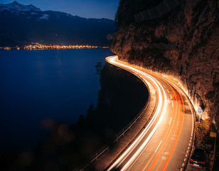 lighttrails of a s-curved street along Lake Thun during the Blue hour
