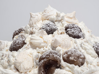 Delicious sweet mont blanc. Dessert made with whipped cream, meringues, marron glacé and covered with icing sugar