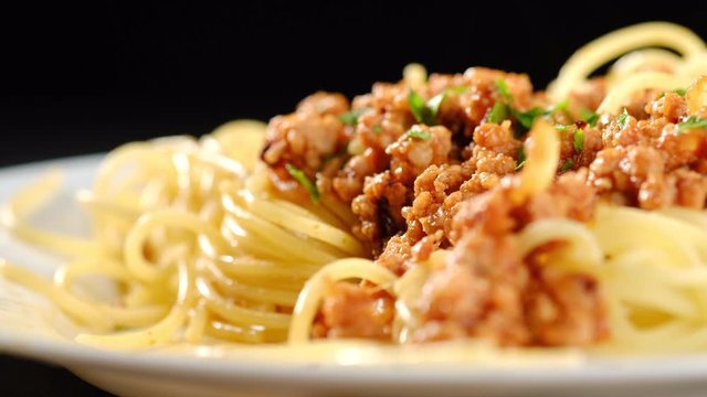 twisting fork with spaghetti pasta and forcemeat closeup