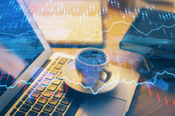 Financial graph colorful drawing and table with computer on background. Multi exposure. Concept of international markets.