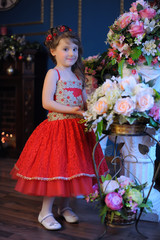 young princess in a red dress among flowers
