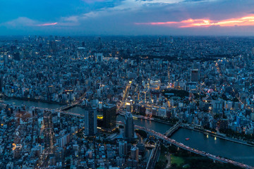 Obraz premium Cityscape of Tokyo from the Skytree at sunset. From the observation deck is possibile to see Asahi building headquarters and Sensoji temple