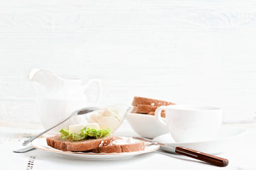 The table is served with white dishes on a white tablecloth.