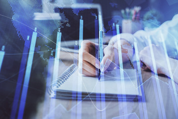 Forex chart displayed on woman's hand taking notes background. Concept of research. Double exposure