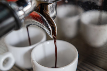 Barista making a cup of coffee soft focus image 