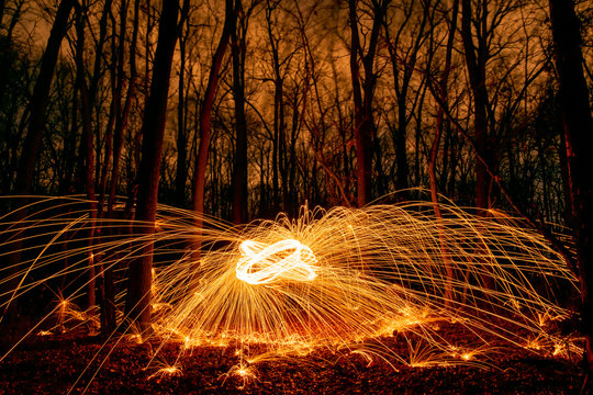 Abstract Image of Burning Wirewool being used to make circle like light trails at Night