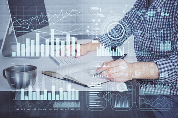 Double exposure of stock market chart with man working on computer on background. Concept of financial analysis.