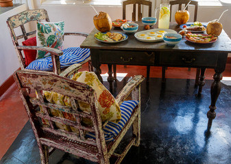 Colorful table and furniture in Sri Lanka Villa, covered with variety of natural healthy food with fruit on terrace.