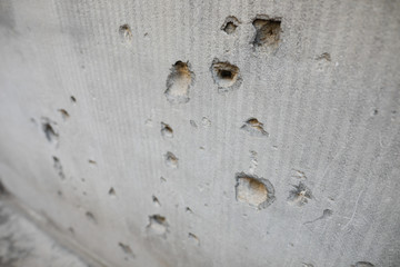 Details with bullet holes in a wall from the Romanian anti communist revolution from 1989.