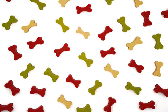 top view of pattern of colorful dog treat or snack in bone shape ,for dog lover background , on white background