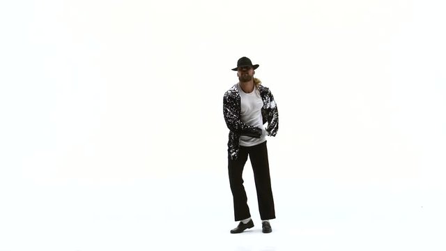 Young stylish teenager is showing dance moves. Isolated over white background. Close up, slow motion.