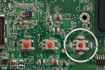 Button on laptop motherboard in detail.