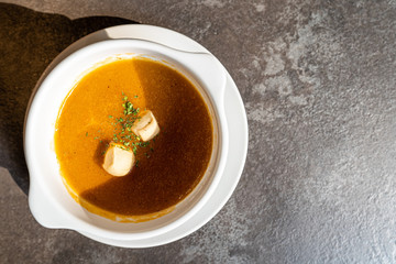 Lobster soup with crumb bread on the rock table