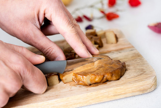 man cutting a piece of seitan