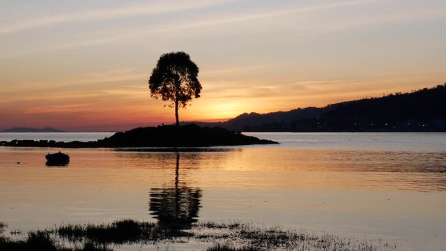 silhouette of a small island at sunset in ria de Pontevedra, Spain