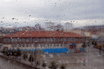 natural rain droplets and outside landscape view on the glass,