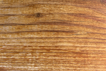 Fototapeta premium Pine wood texture. Flat old vintage pine board surface with knots and curving layers. Top view, Red-brown color tone.