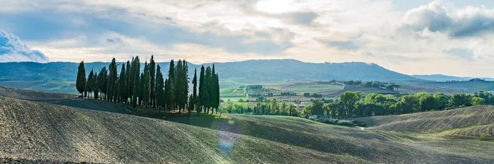 Fotobehang Tuscany landscape at gentle sunset light. Typical for the region tuscan farm houses, hills, vineyard. Italy, Europe. Wide banner. © Leonid