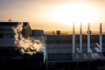 Sheffield city frosty golden sunrise. Aerial view looking over factories with steam from chimneys on a cold winters day in December 2019, South Yorkshire, UK