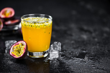 Slate slab with Maracuja Juice (selective focus; close-up shot)
