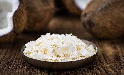 Some healthy Coconut Chips (selective focus; close-up shot)