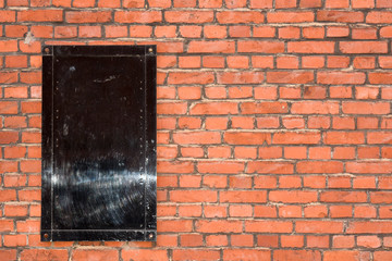 brick wall with black board