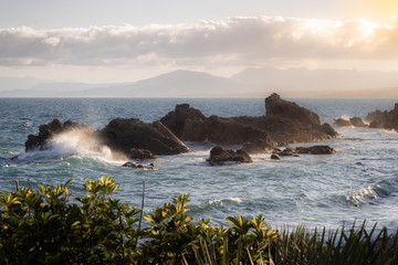 Waves crashing on rocks in the Mediterranean sea during sunset