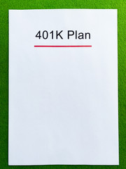 Paper with 401k plan on green background.