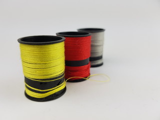 Sewing thread in black roller on white background