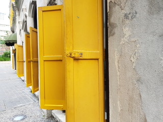 Yellow wooden windows at old histric bulding in a town