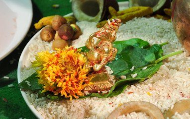 Traditional puja of Ganesh idol with flowers and tilak