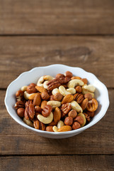 mixed nuts on wooden surface