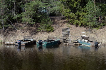 Motor boats near the shore Tornincasa channel. Vologda region