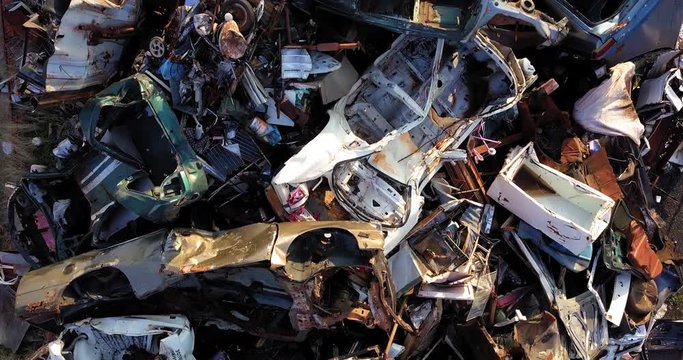 Steel scrap mountain, ready for recycling, will be melted down and made into raw material again for use in the industry. Aerial camera.